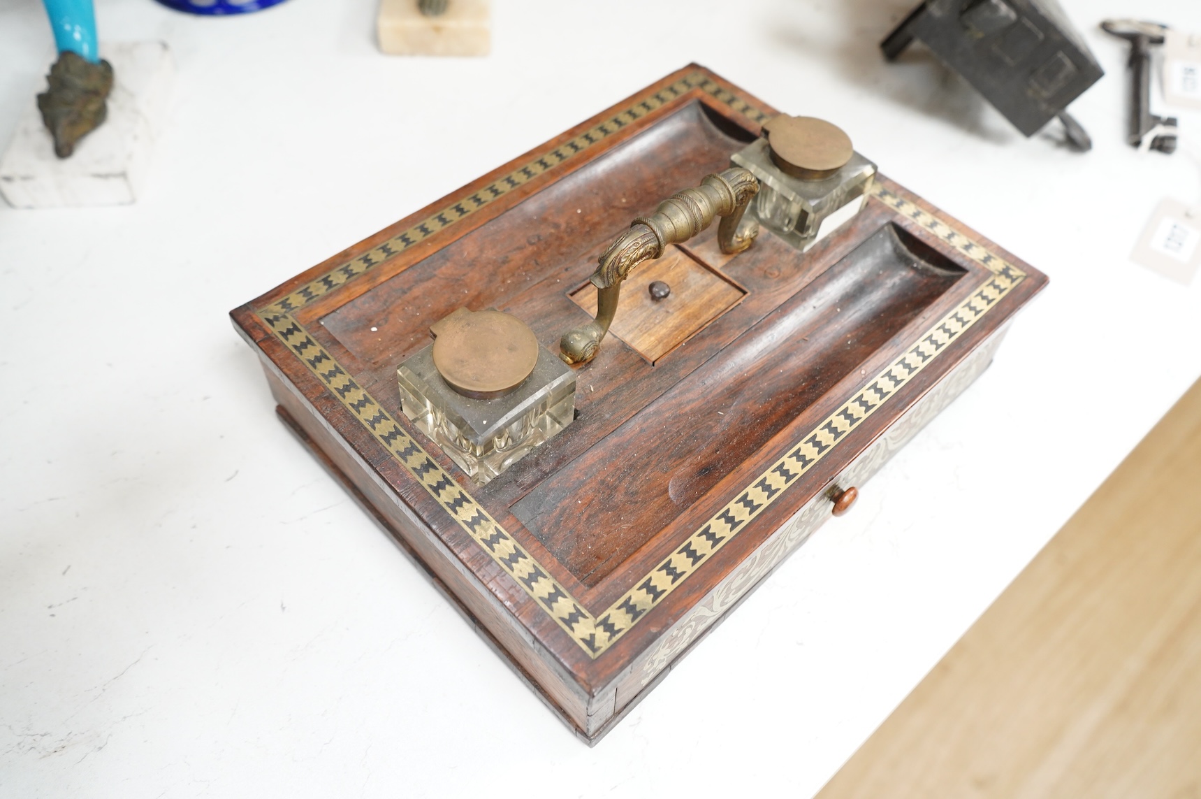 A George IV rosewood and cut brass inlaid two desk top inkstand, 29cm wide x 22cm deep